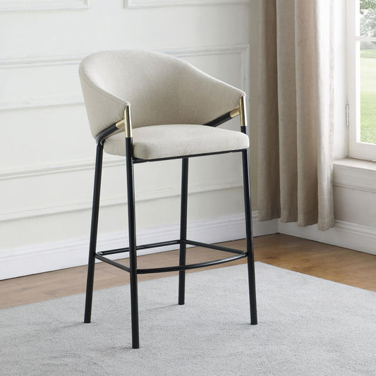 Beige boucle fabric bar stool with black metal legs and gold accents
