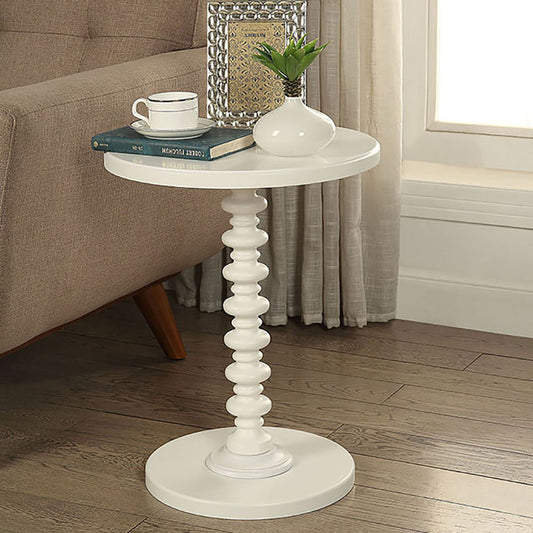 White round accent table with beaded pedestal base and sofa