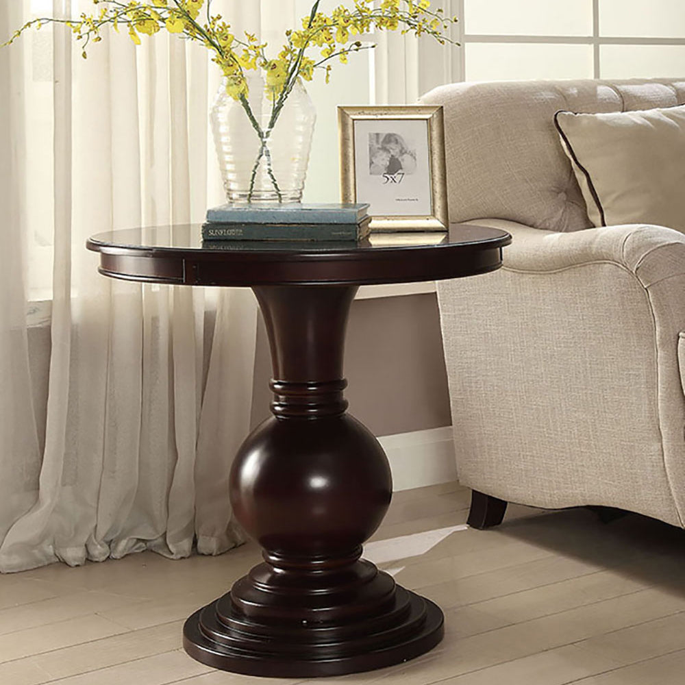 Dark wood pedestal end table with ornate carved base ideal for living rooms