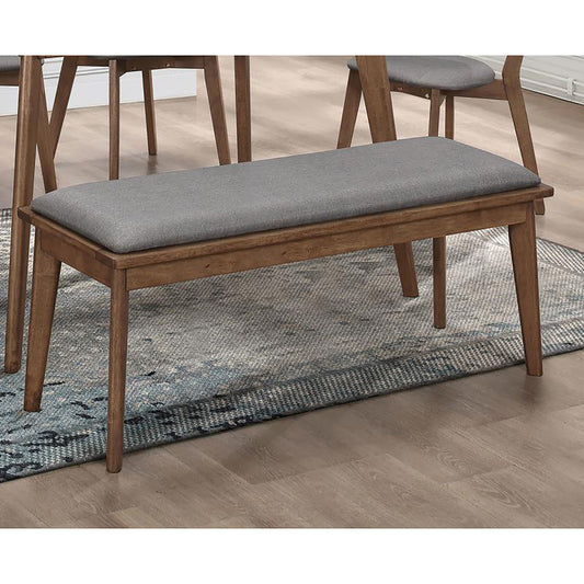 Wooden dining bench with upholstered grey seat on a blue patterned rug