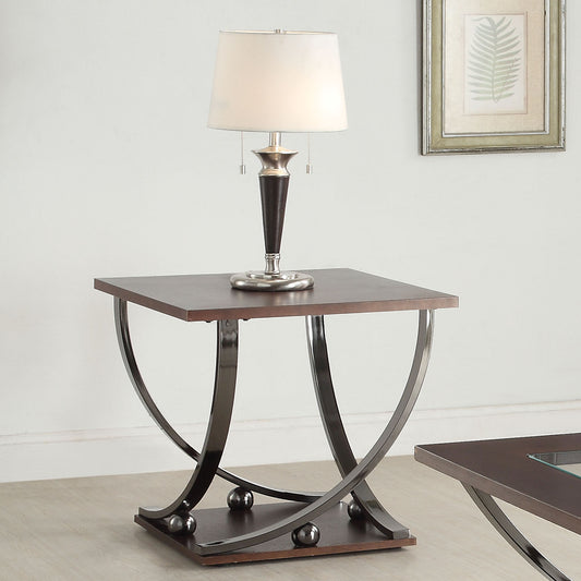 Dark wood and chrome accent table with a modern curved base and metallic spheres