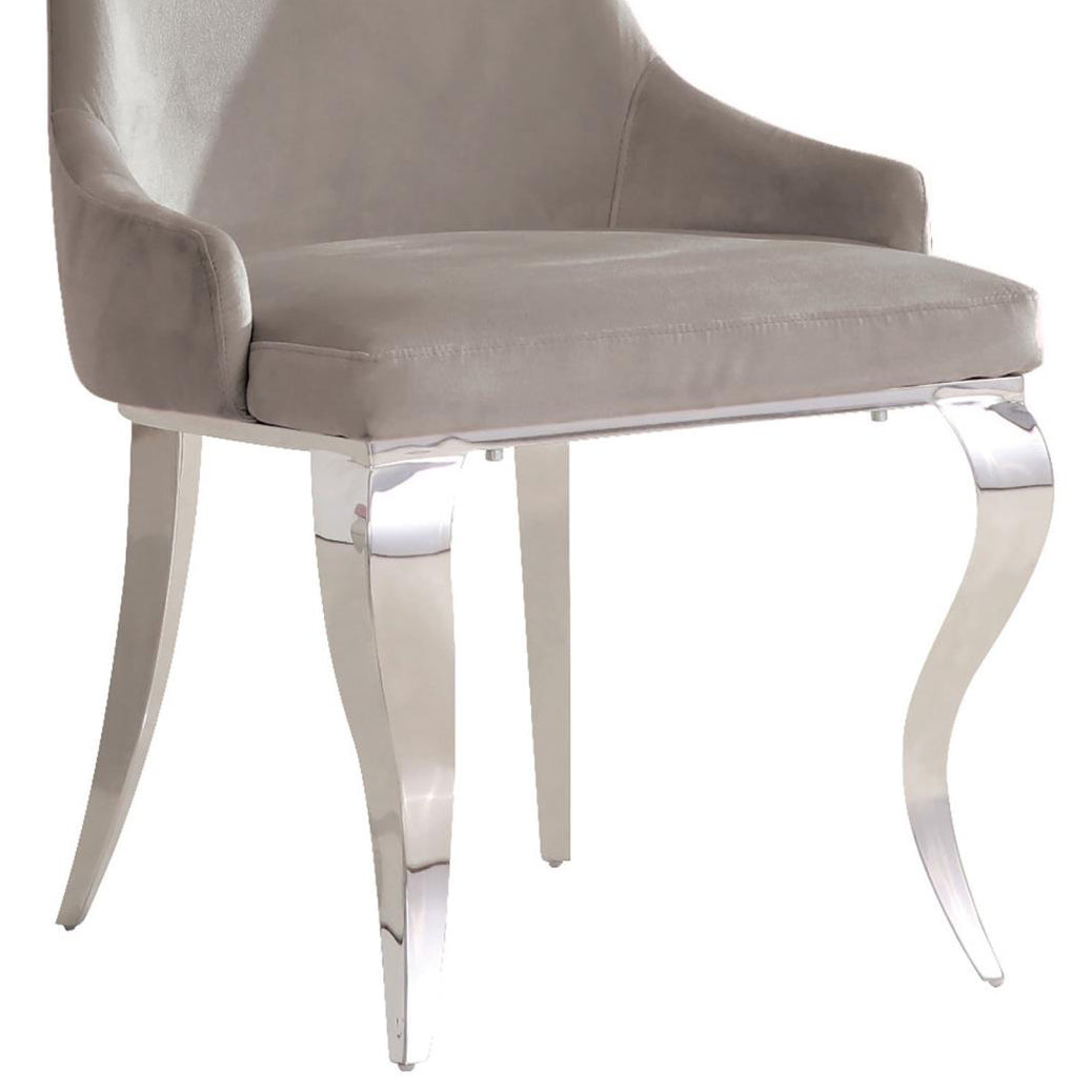 Luxurious grey velvet dining chair with elegant curved chrome legs perfect for a modern interior