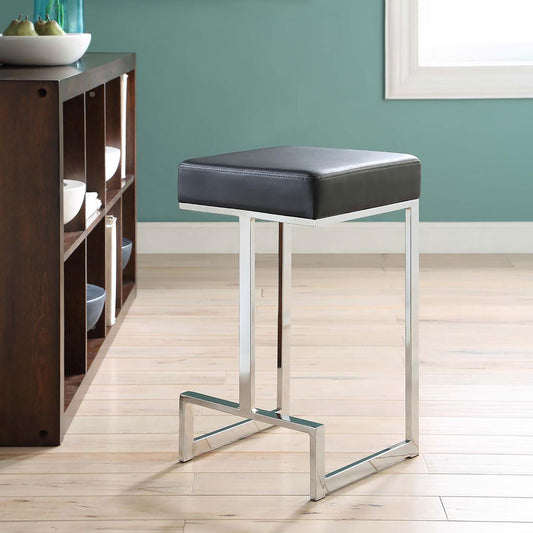 Black leatherette bar stool with polished chrome frame and footrest