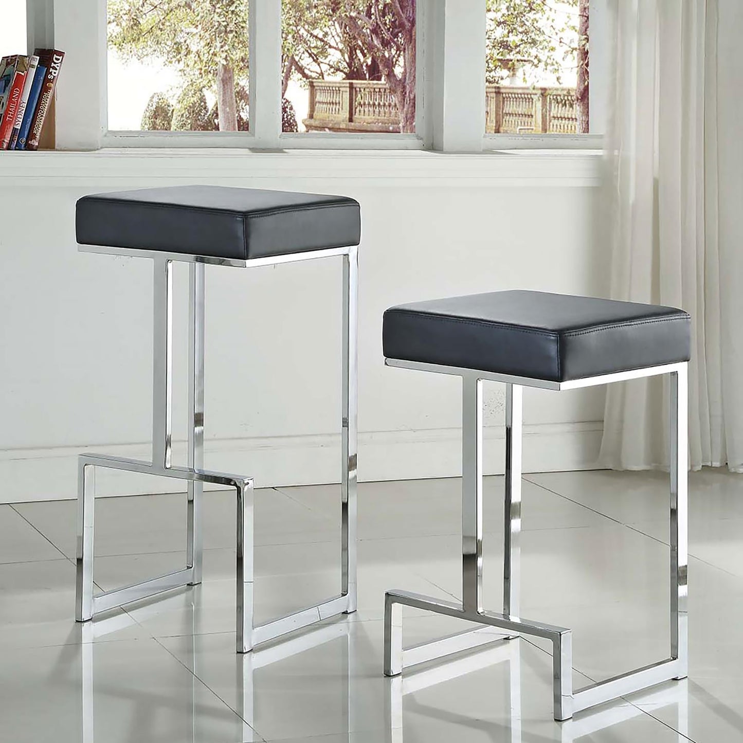 Modern black faux leather bar stool with polished chrome frame ideal for kitchen islands