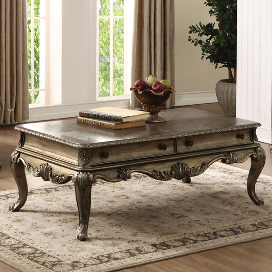 Antique ornate coffee table with carved legs and decorative drawer pulls suitable for a classic living room
