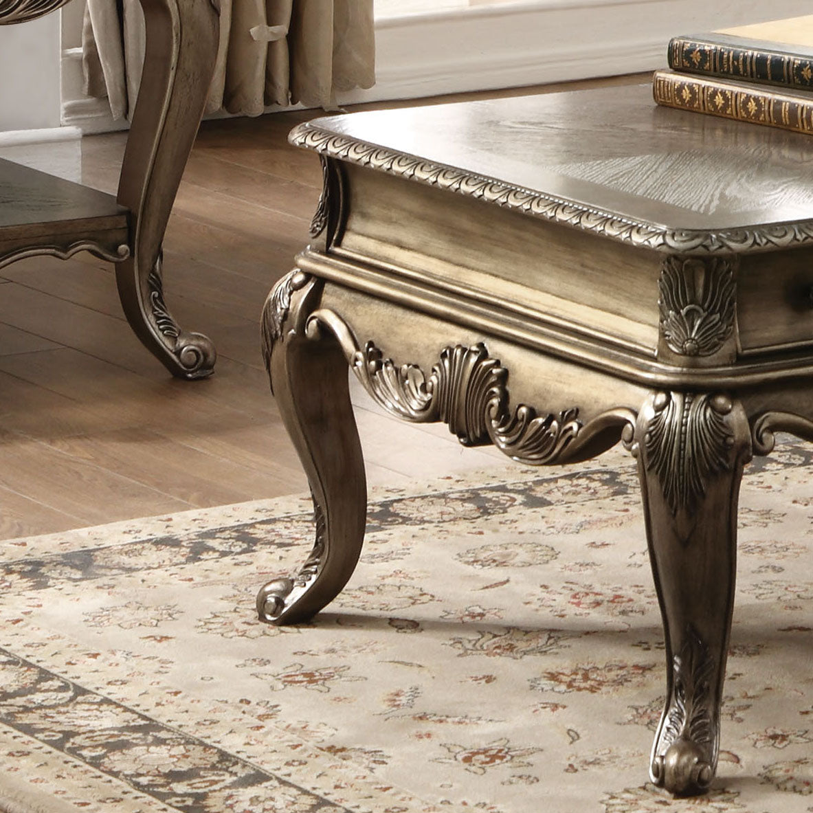 Antique gold carved coffee table with ornate legs and decorative trim