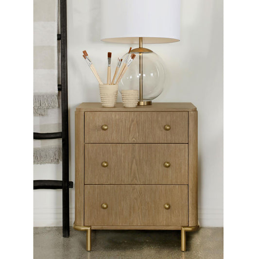 Light oak bedside table with three drawers and brass hardware