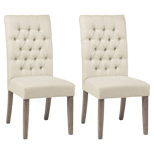 Two beige upholstered dining chairs with diamond tufting and grey wooden legs