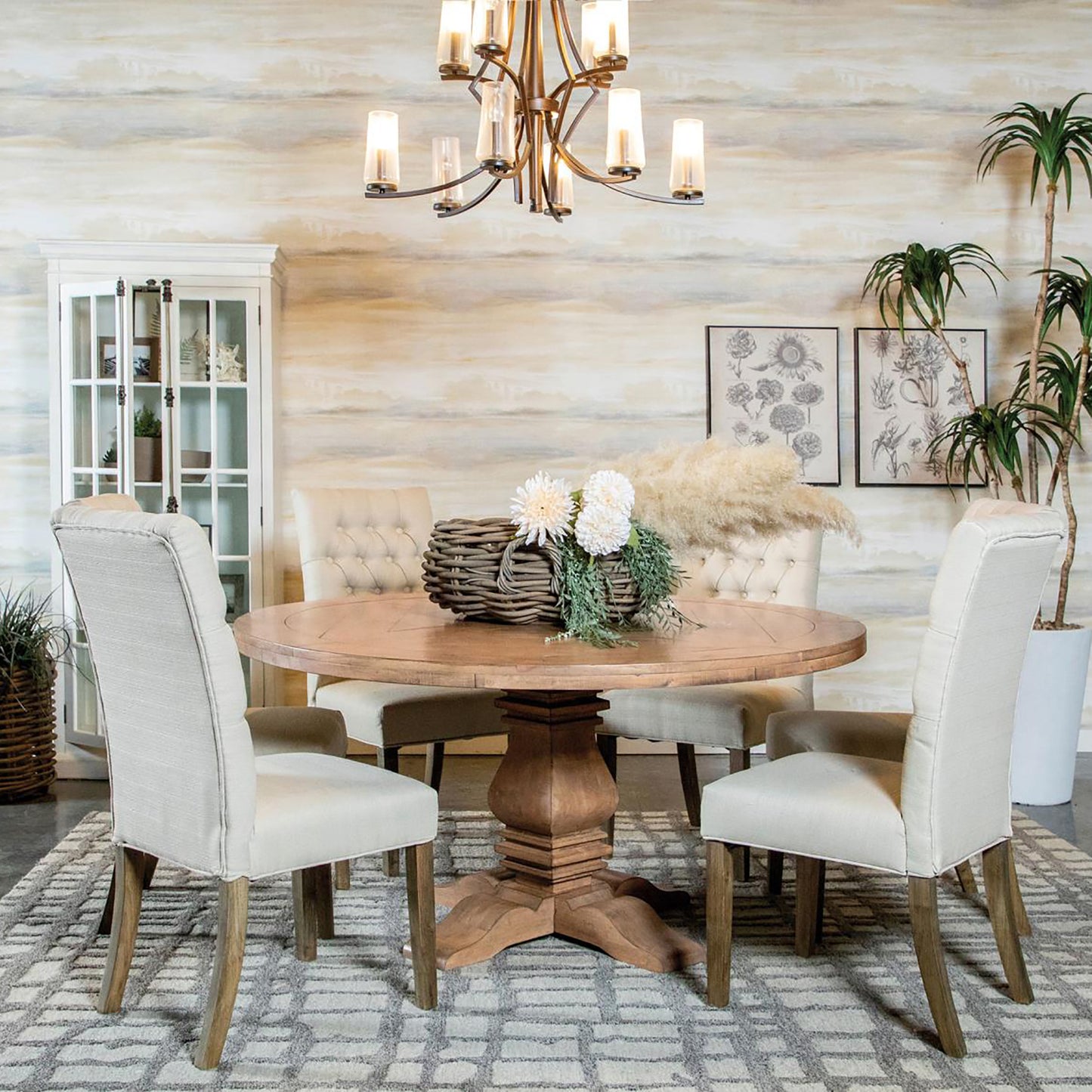 Round wooden dining table with pedestal base and upholstered chairs for dining