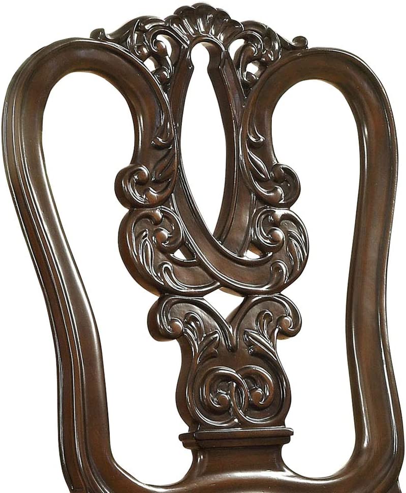 Intricate carved dark brown wood ornate dining chair back detail