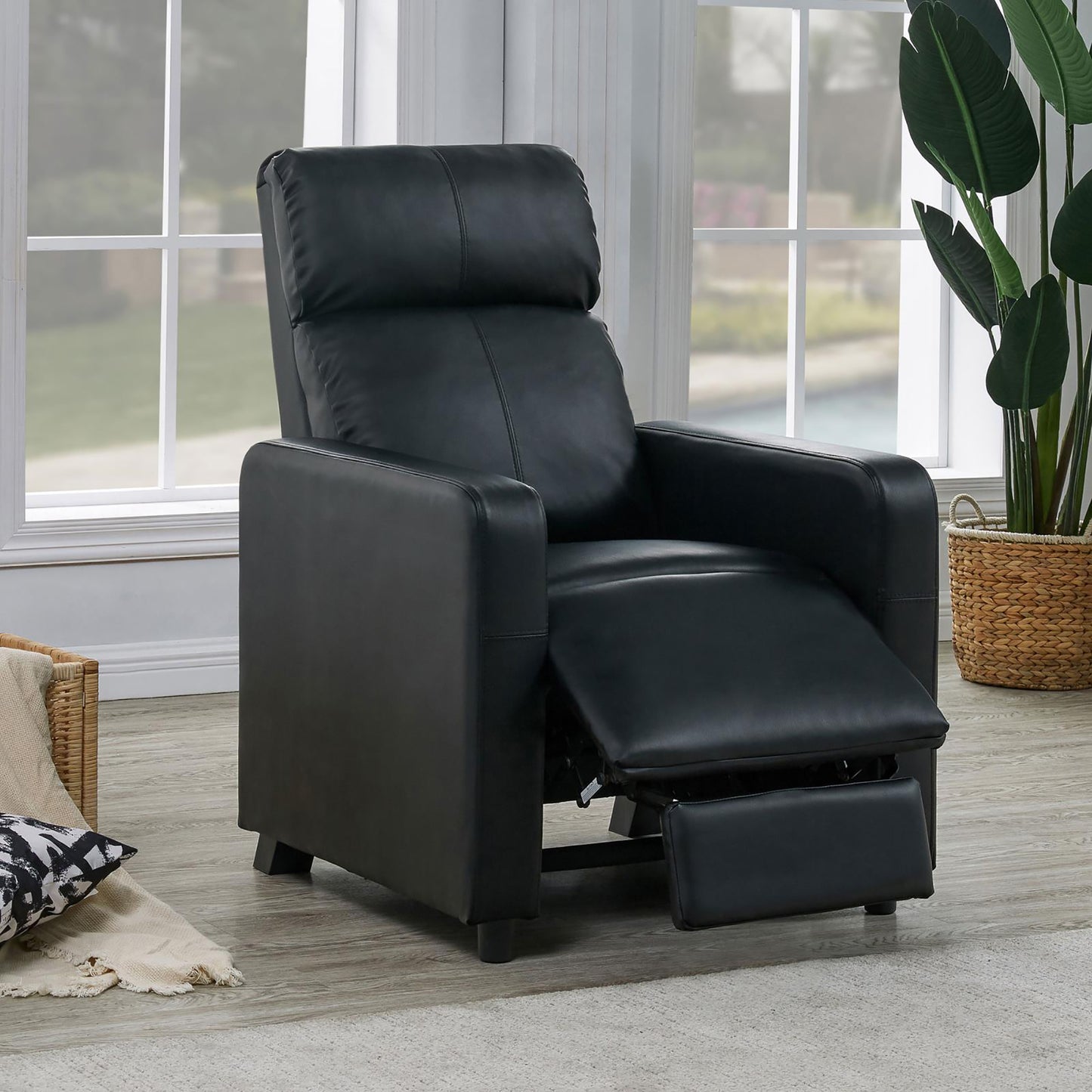 Black leather recliner with extended footrest perfect for living room relaxation