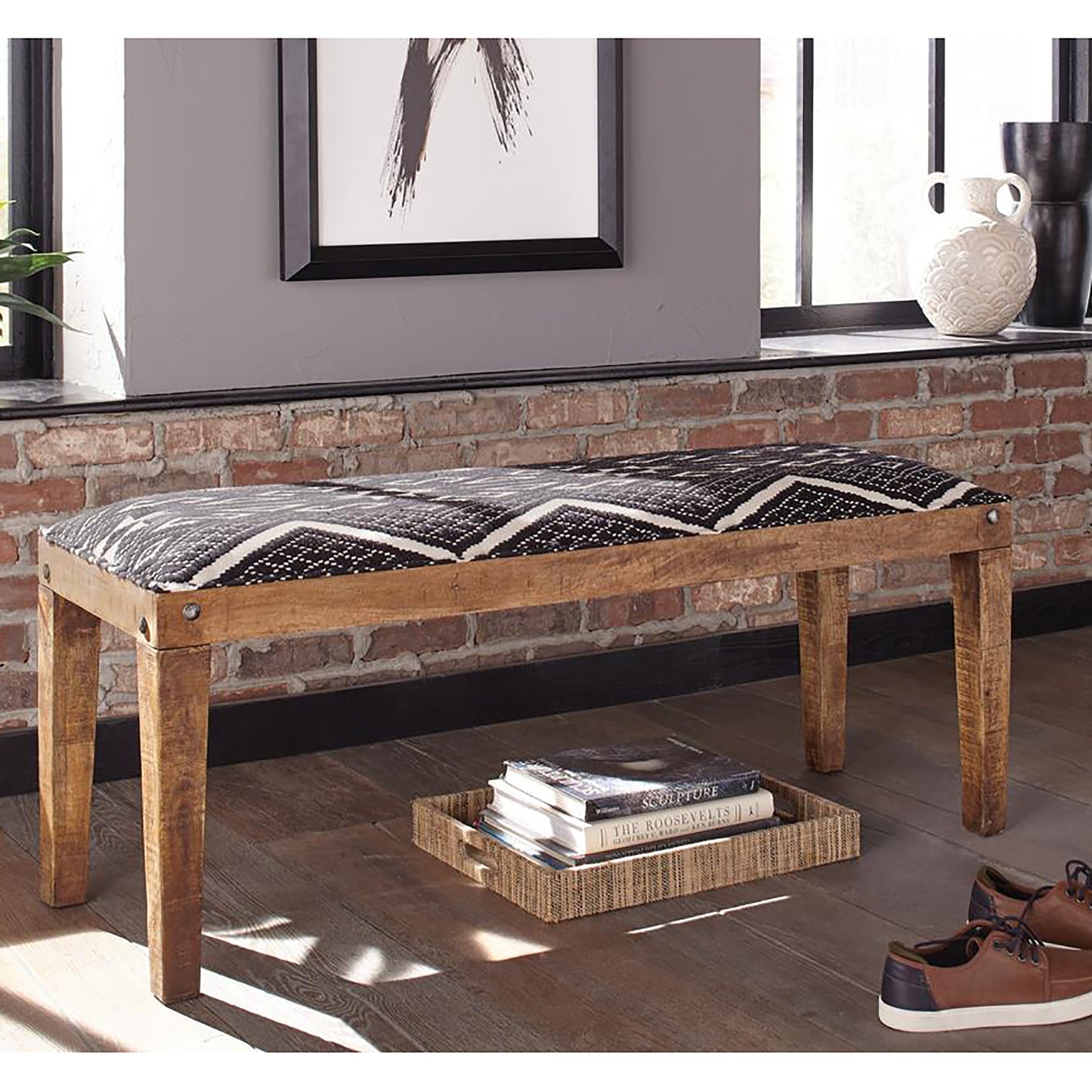 Wooden bench with black and white geometric patterned cushion  characters