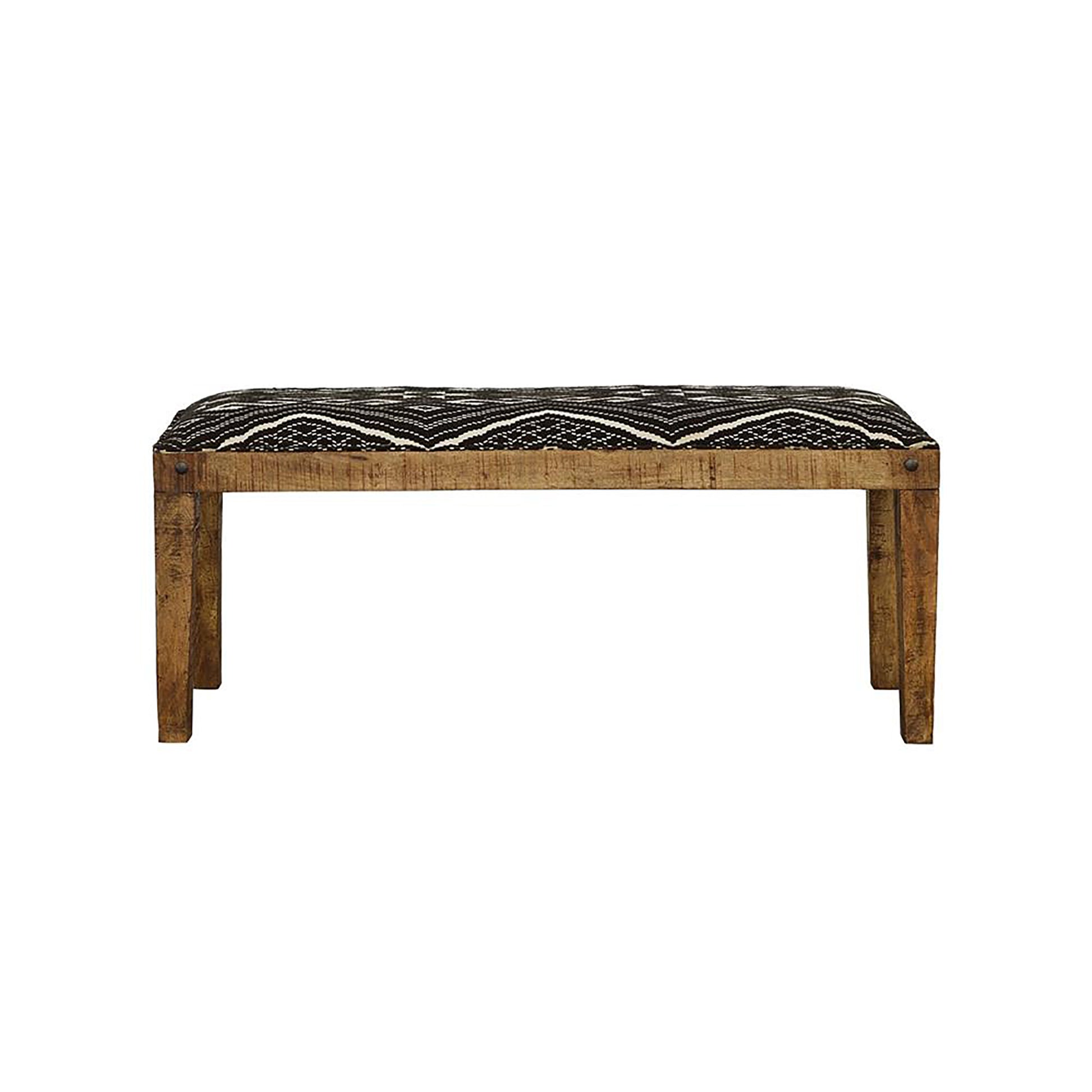 Rustic wooden bench with black and white geometric patterned upholstery