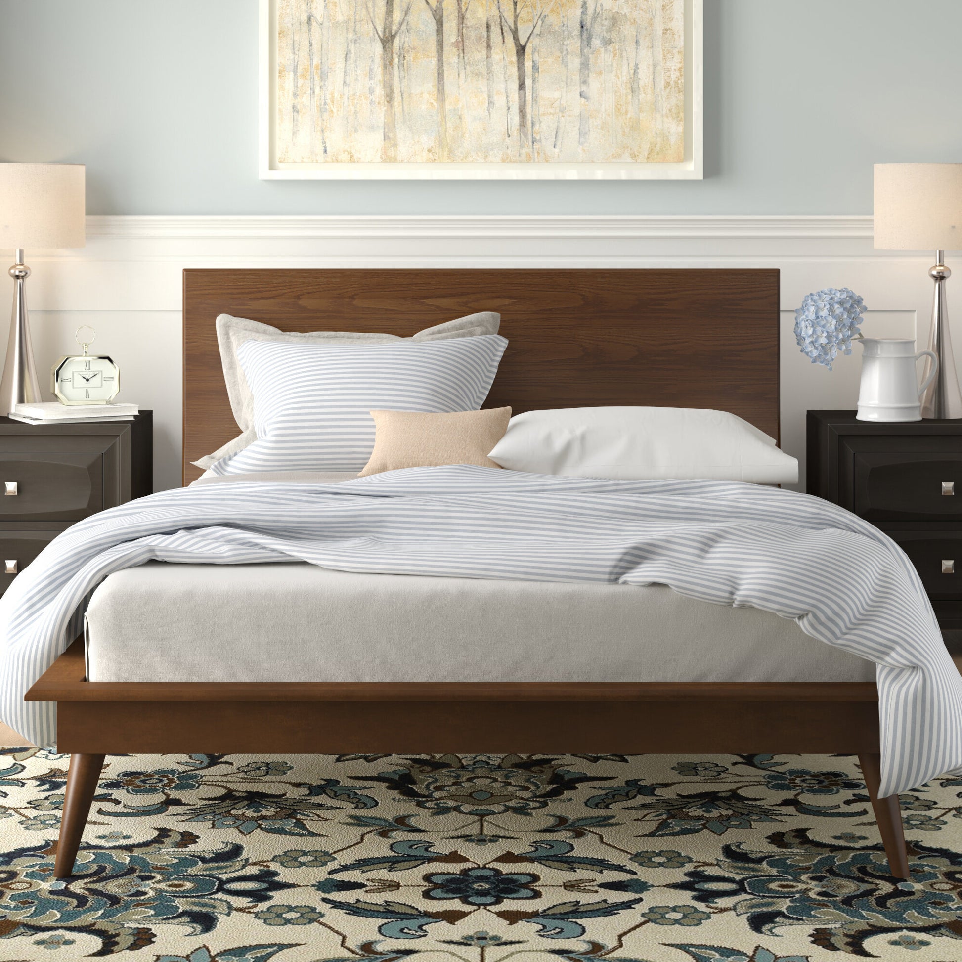 Midcentury modern platform bed with walnut finish and striped bedding