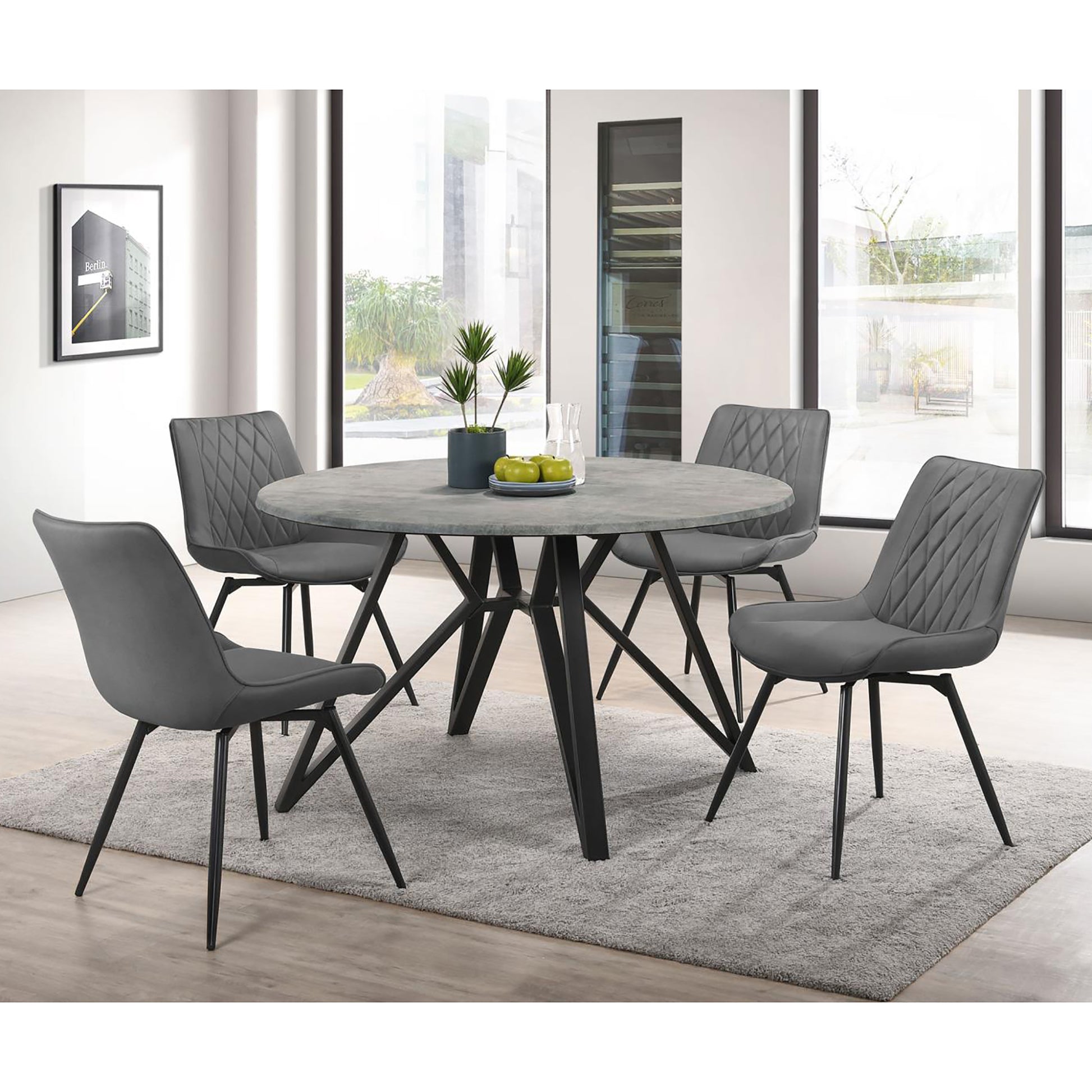 Round concrete dining table with four grey upholstered diamondstitched chairs
