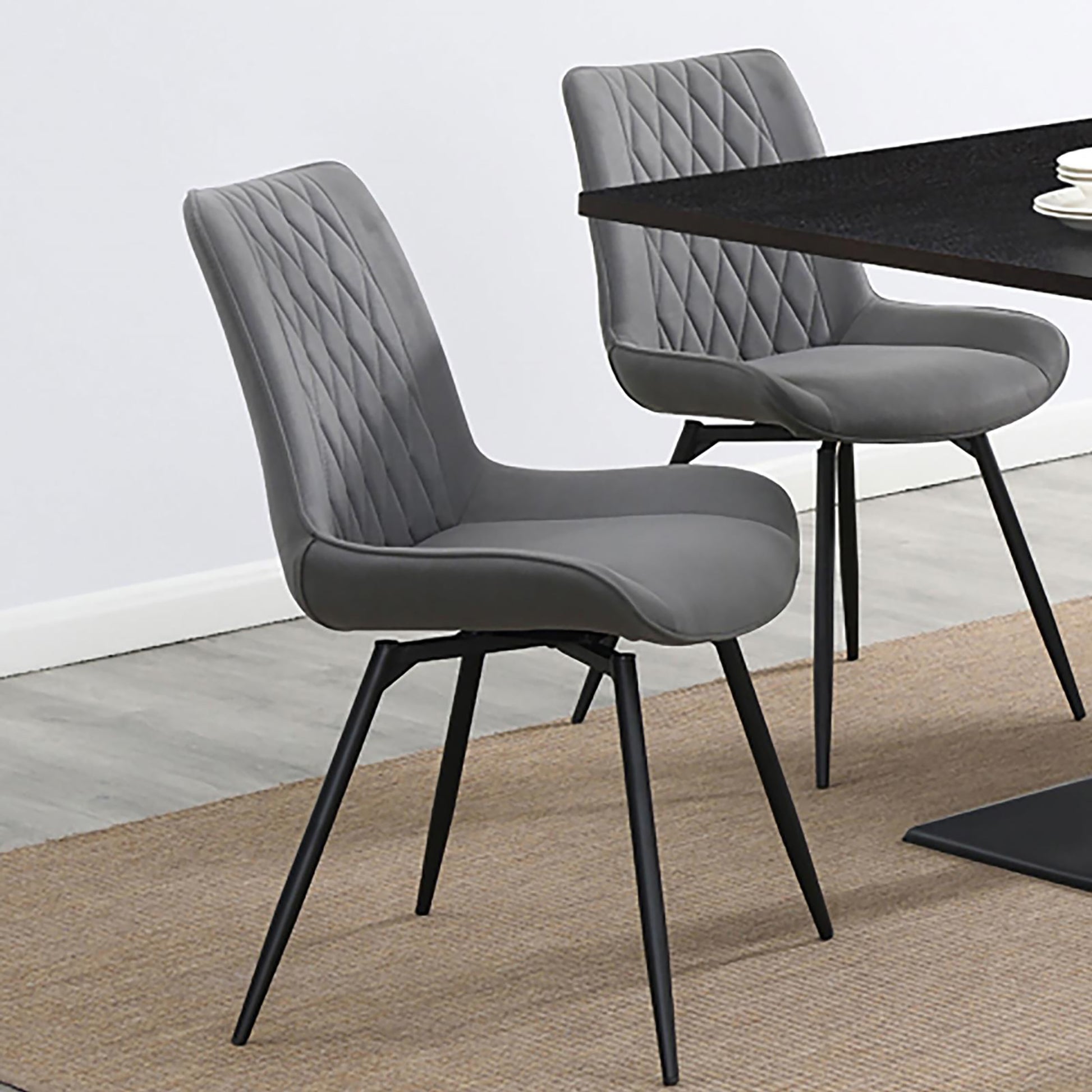 Grey upholstered dining chair with diamond tufting and black metal legs