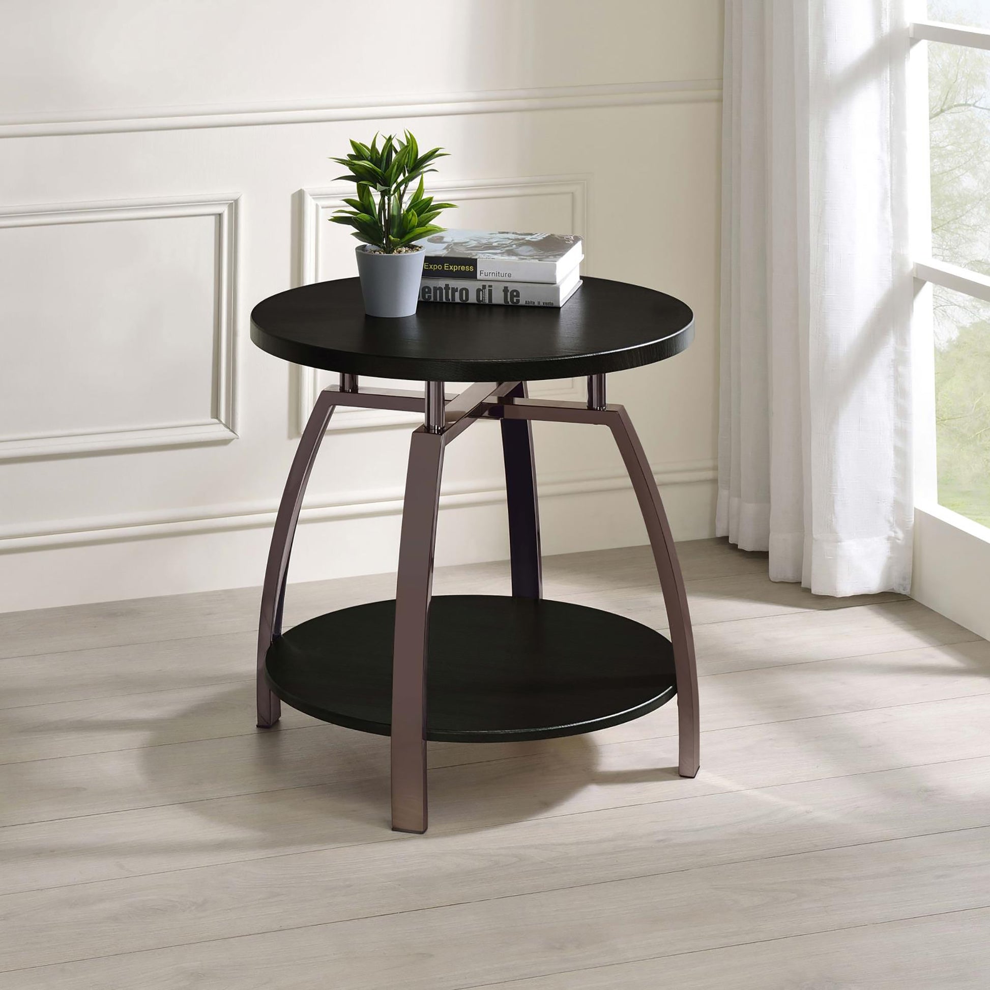Round black accent table with metal legs and a lower shelf