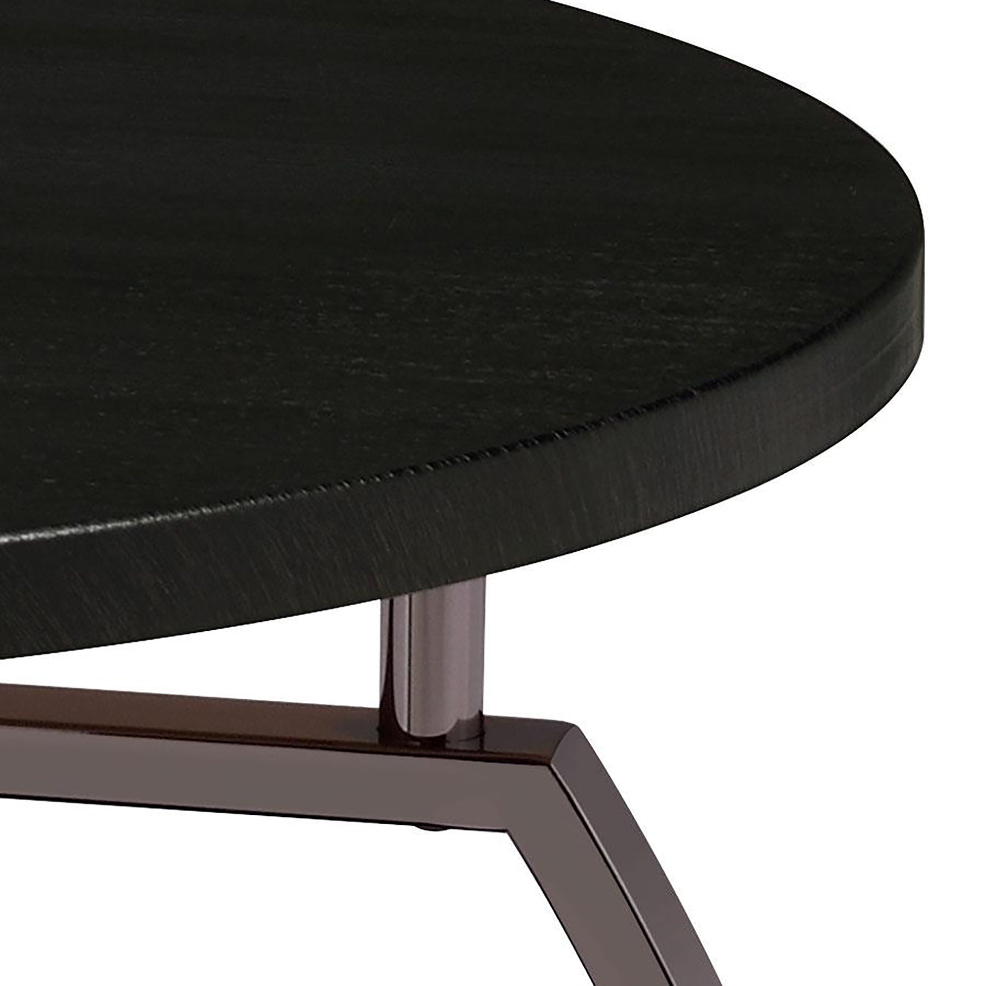 Closeup of a black round wood veneer top accent table with metal legs