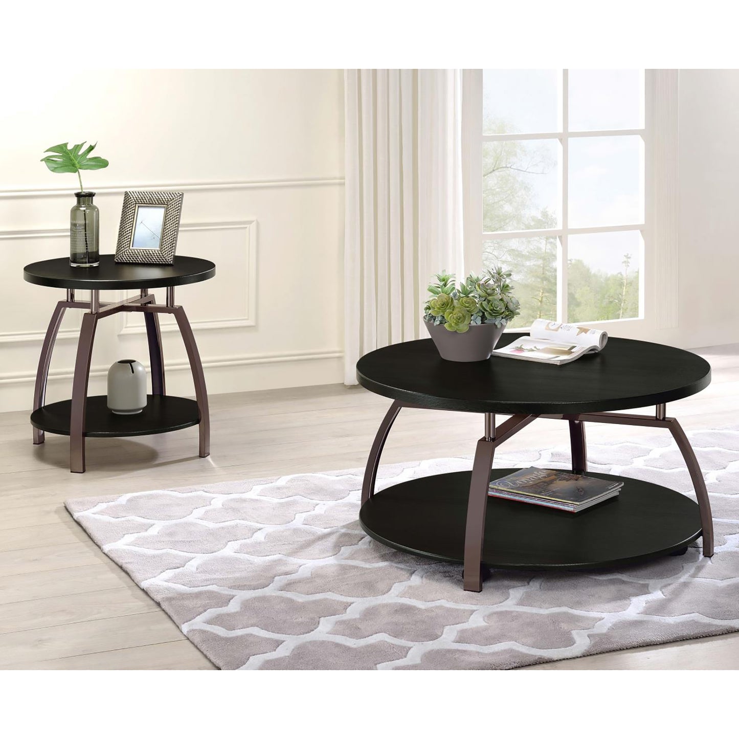 Round black coffee table with metal legs on a patterned rug