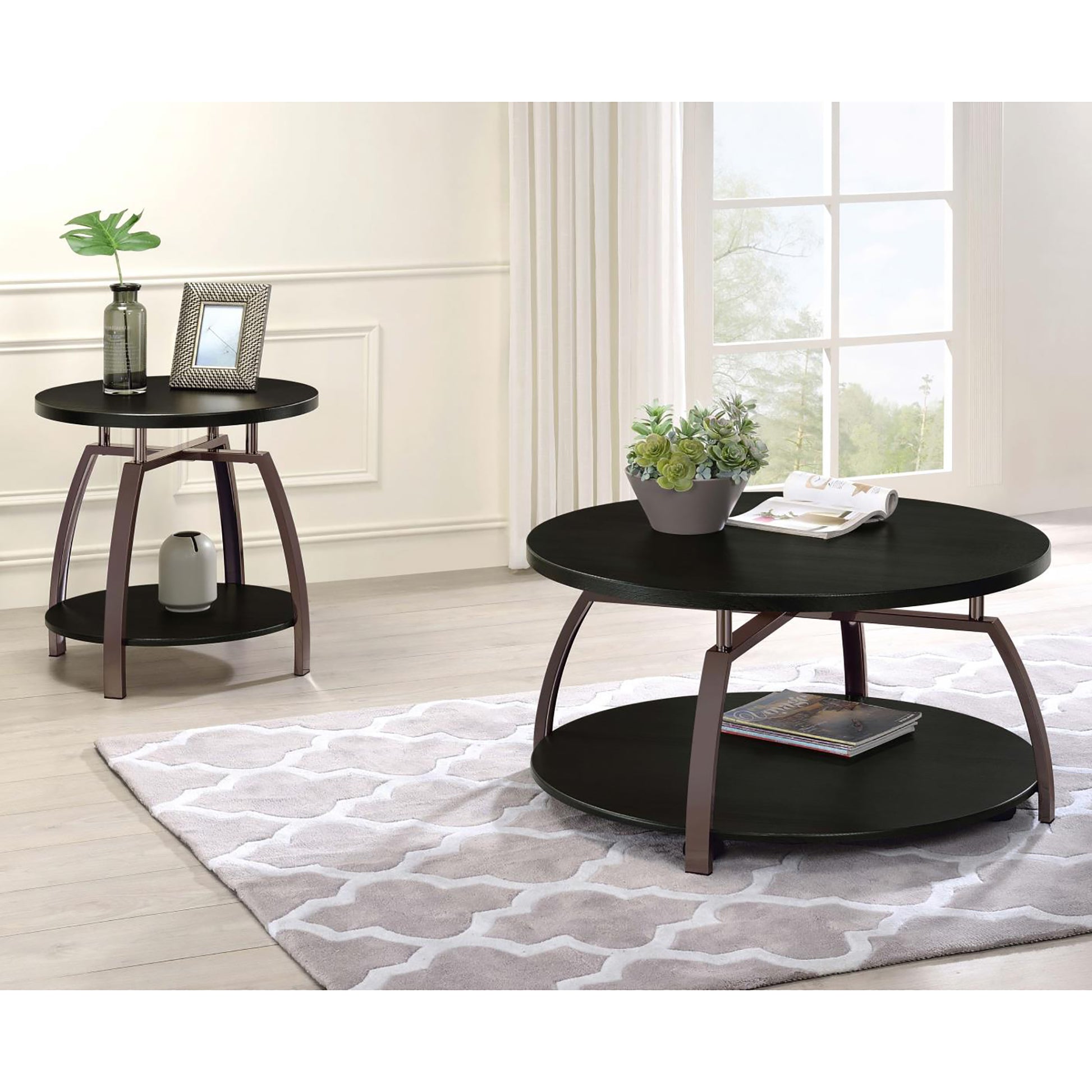 Round black coffee table with metal legs on a patterned rug