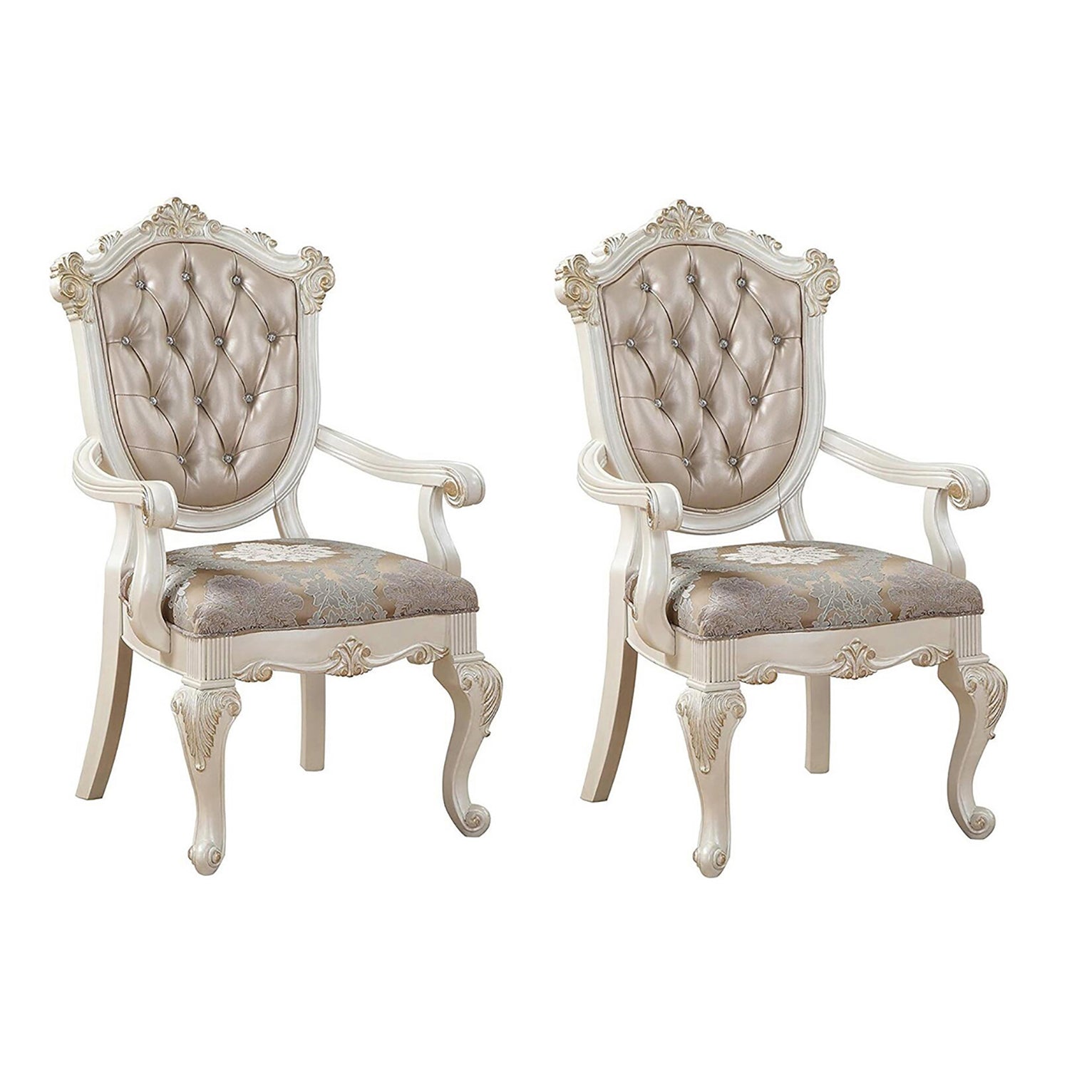 Pair of cream upholstered dining chairs with tufted back and carved wood legs
