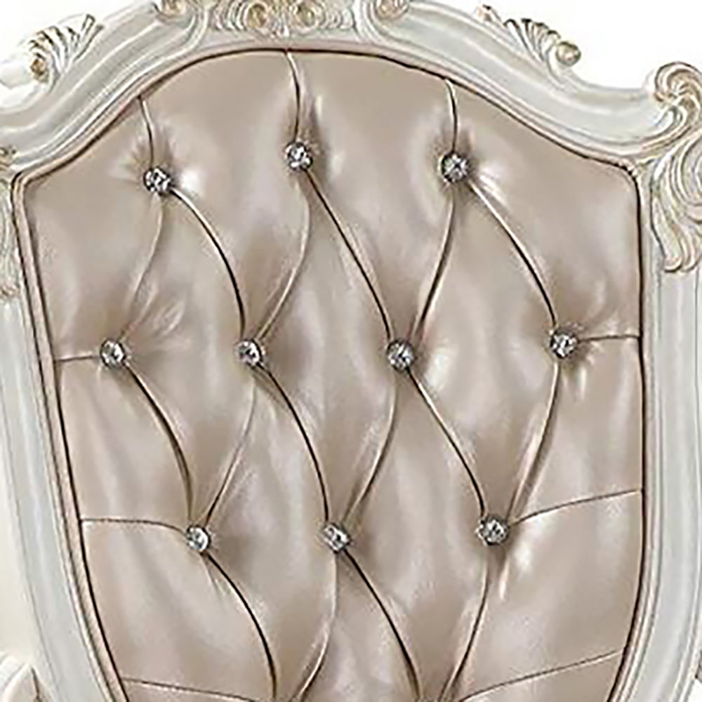 Tufted beige upholstered chair back with crystal accents featuring elegant scrolled woodwork