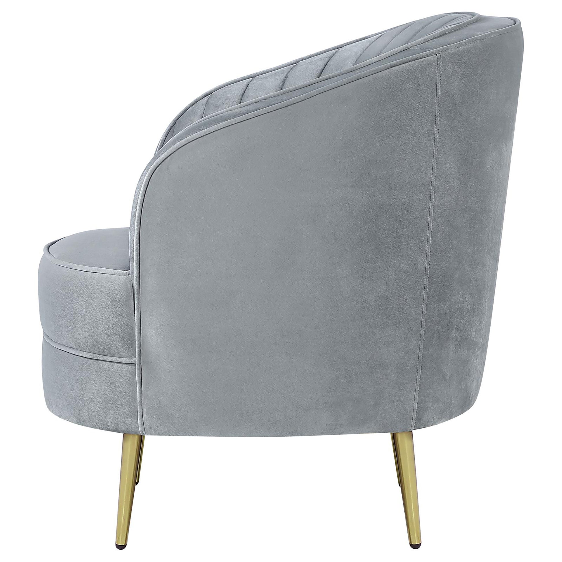 Gray velvet armchair with gold legs featuring channel tufting on the backrest for elegant accent seating