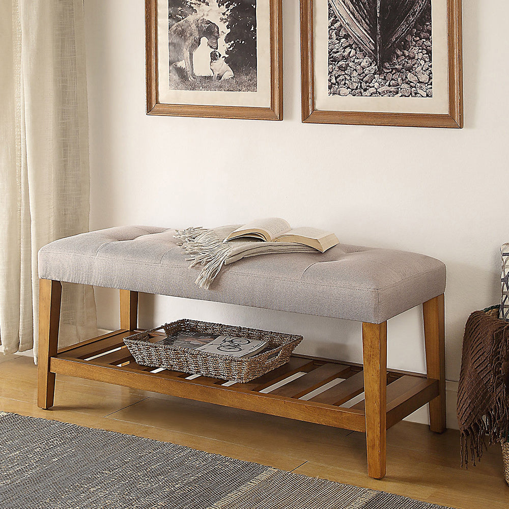 Tufted grey fabric bench with wooden legs and slatted shelf perfect for entryway seating