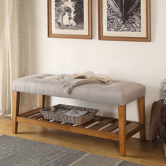 Tufted grey fabric bench with wooden legs and slatted shelf perfect for entryway seating