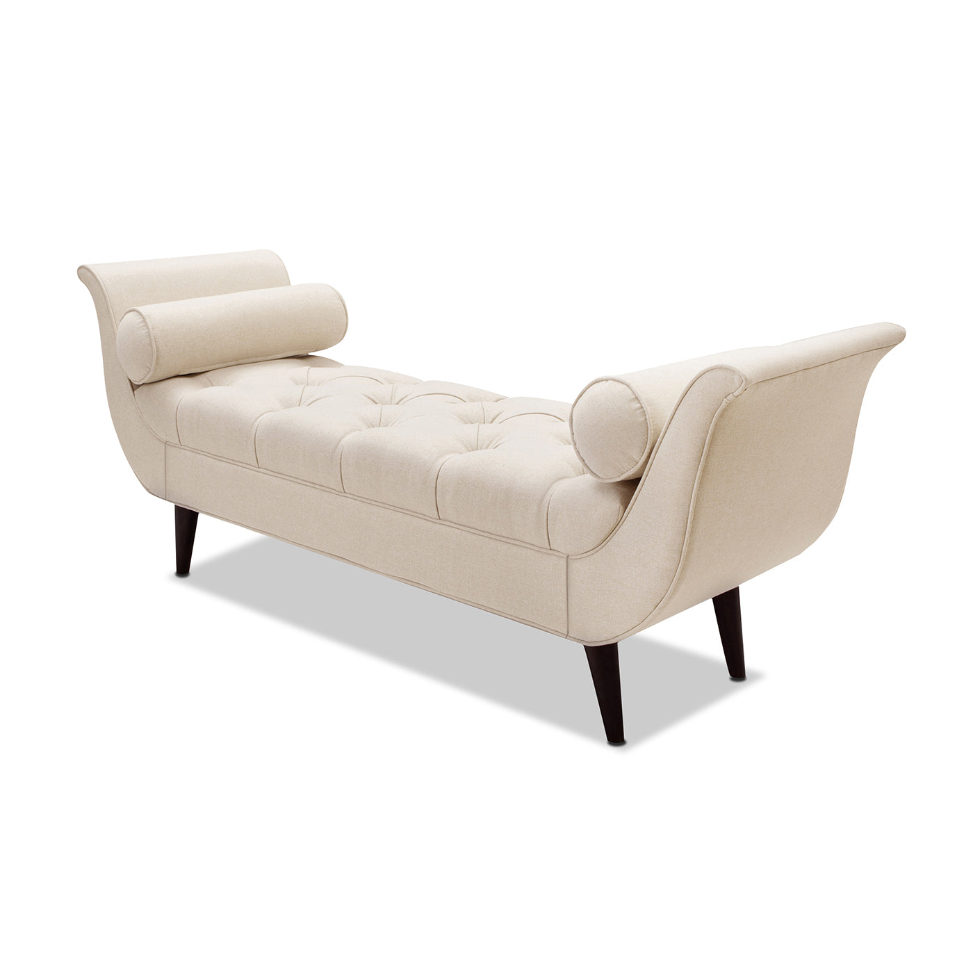 Cream tufted chaise lounge with bolsters and dark wood legs
