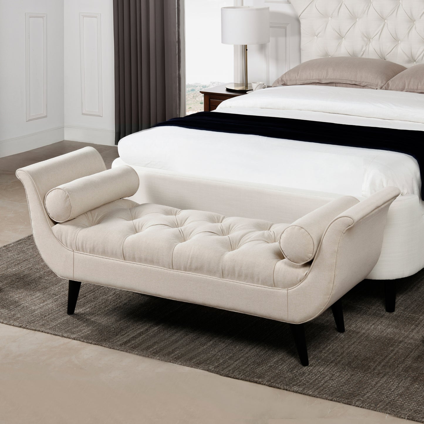 Upholstered beige daybed with tufted seat and rolled arms for bedroom accent seating