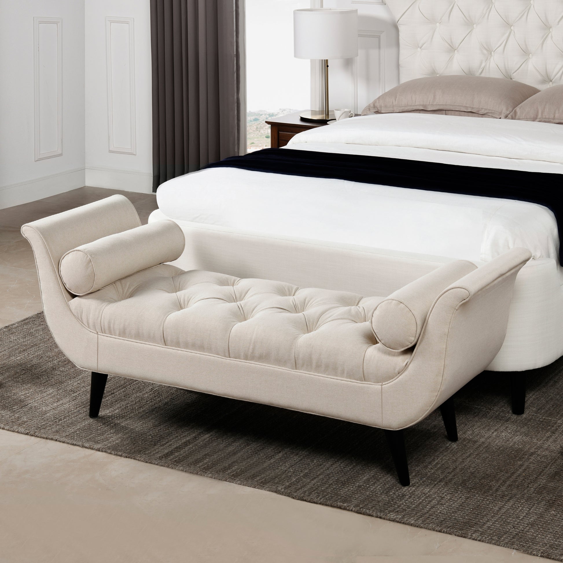 Upholstered beige daybed with tufted seat and rolled arms for bedroom accent seating