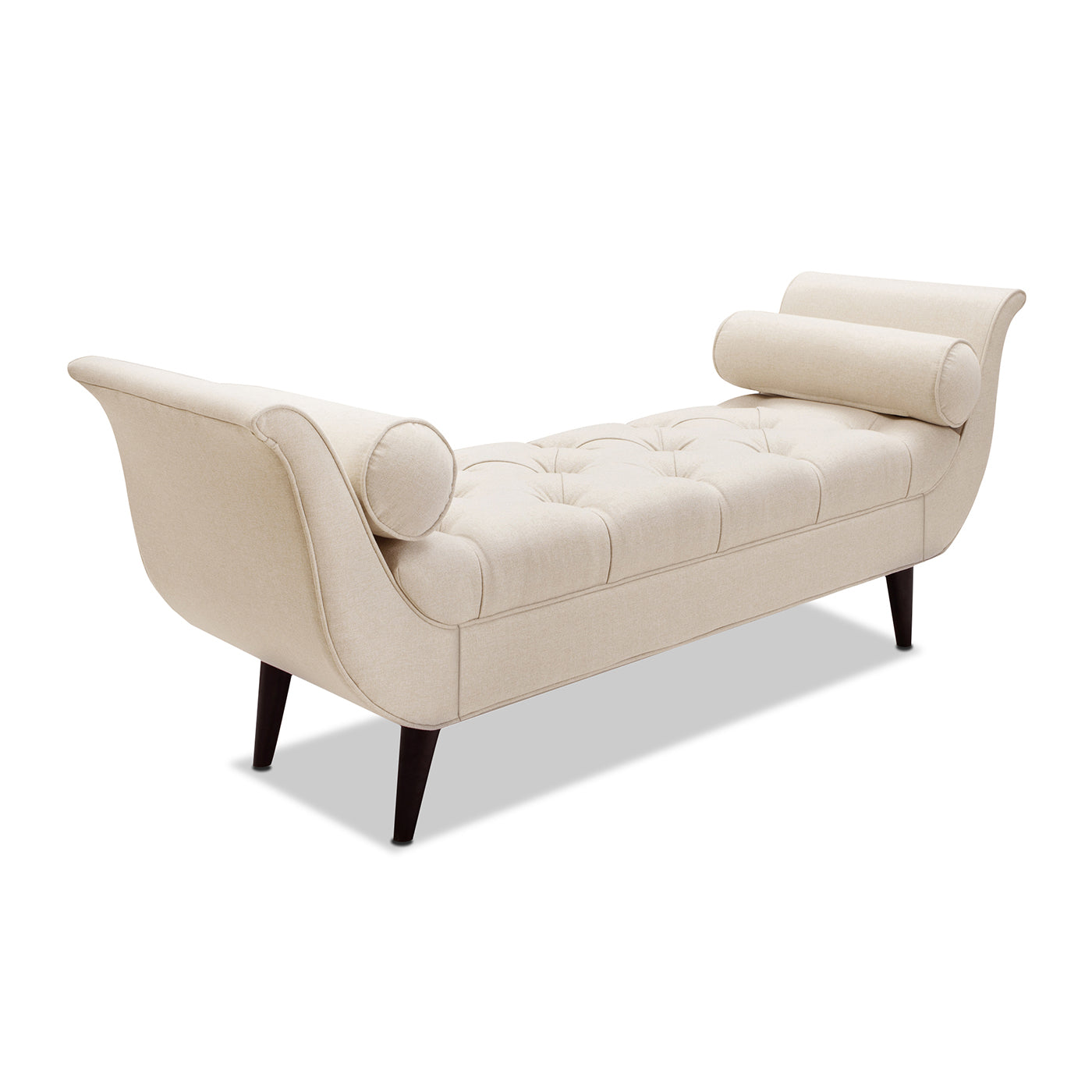 Cream fabric chaise lounge with button tufting and bolster pillows