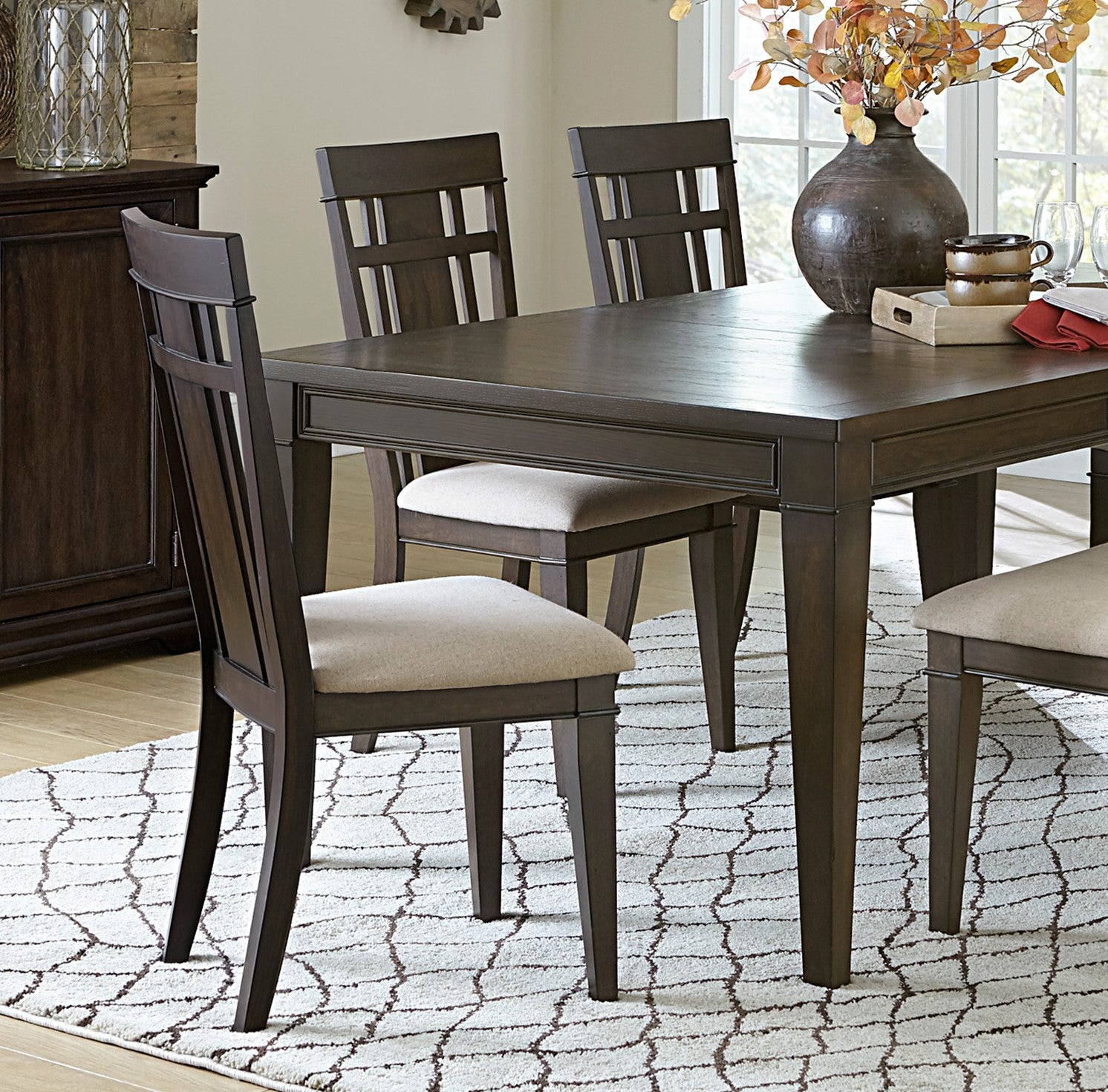 Dark wood dining chair with upholstered seat and geometric back design