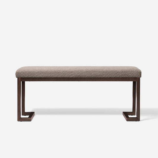 Textured beige upholstered bench with modern dark bronze metal frame