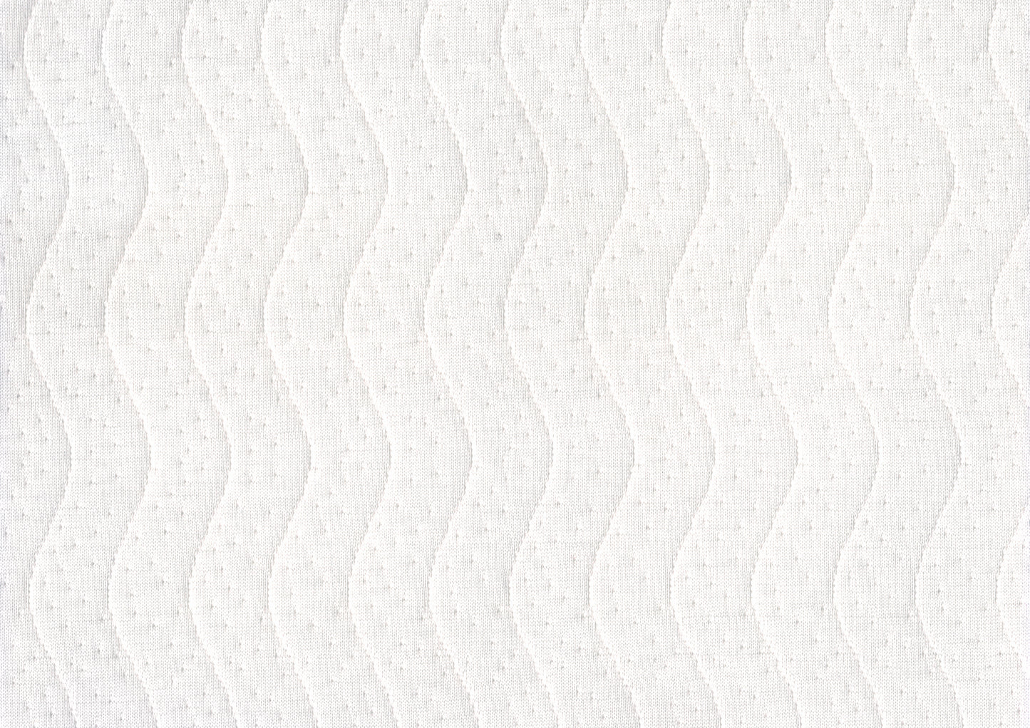 Closeup of white quilted fabric with a subtle wave pattern and raised dot texture