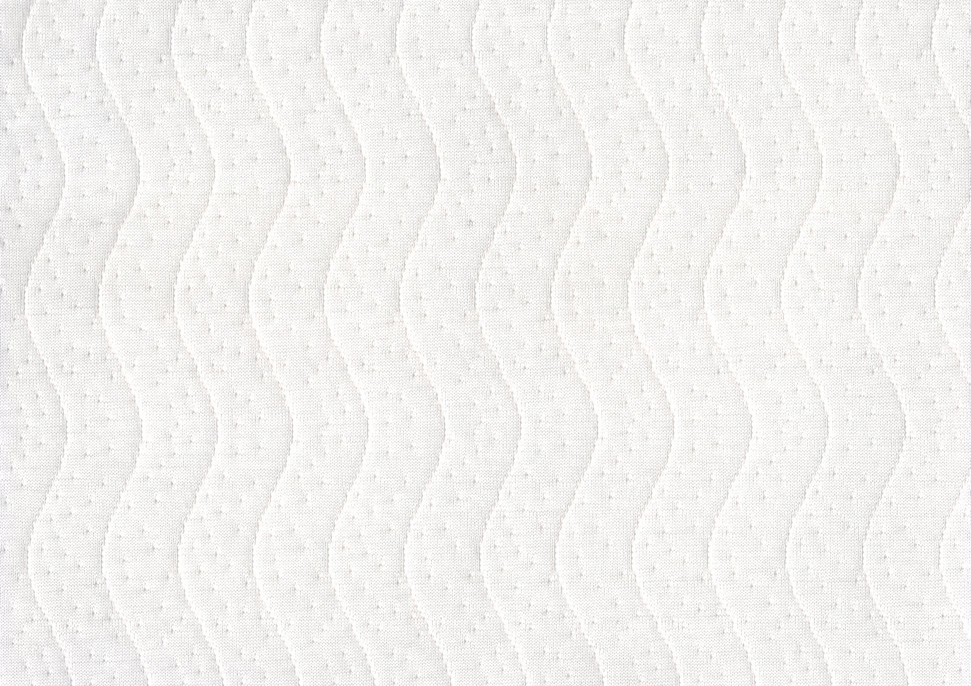 Closeup of white quilted fabric with a subtle wave pattern and raised dot texture