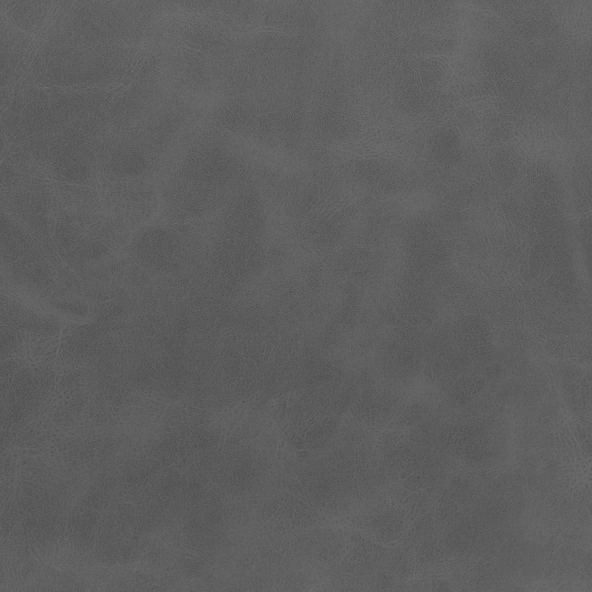Closeup of textured charcoal grey faux leather fabric swatch