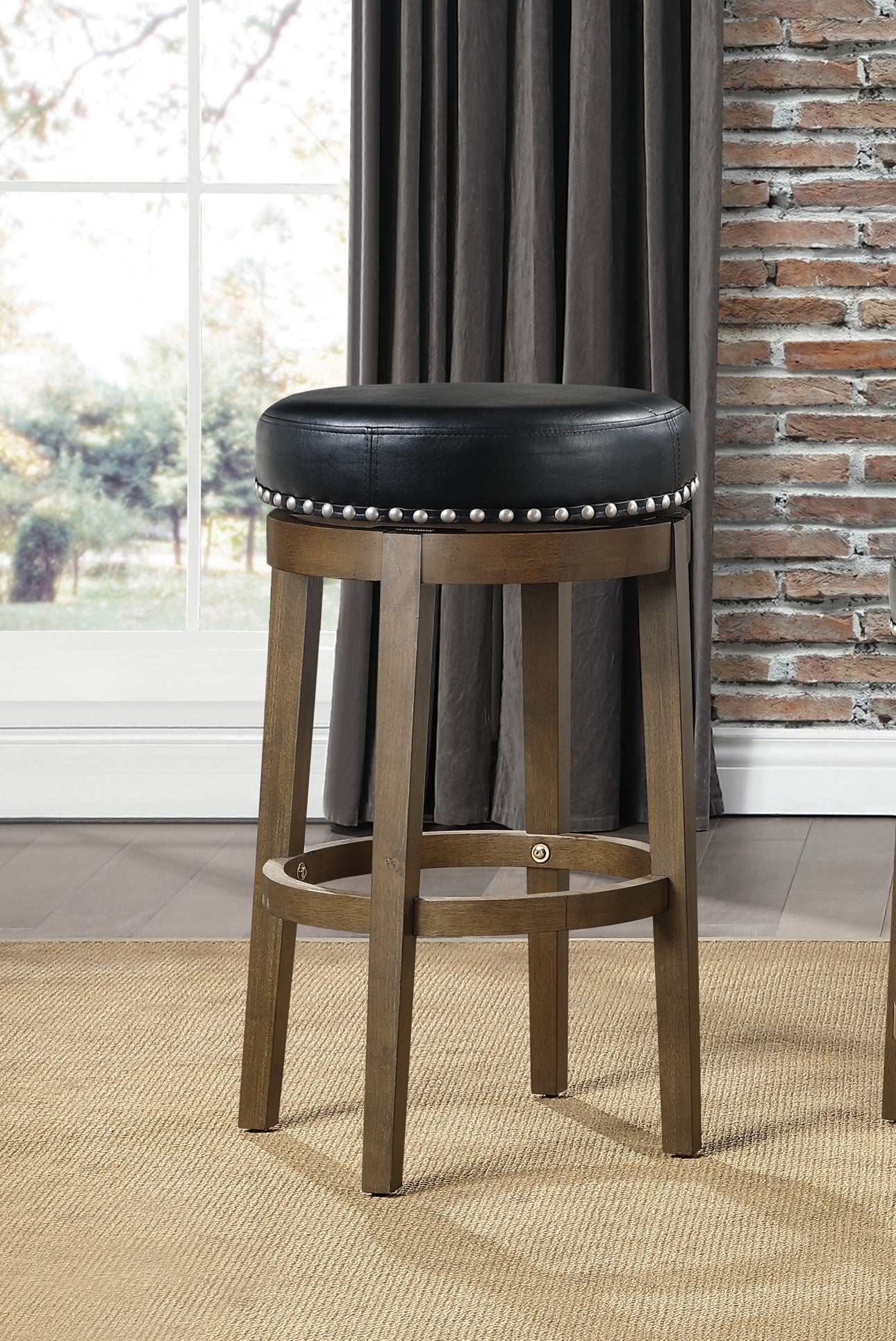 Swivel bar stool with black faux leather seat and silver nailhead trim