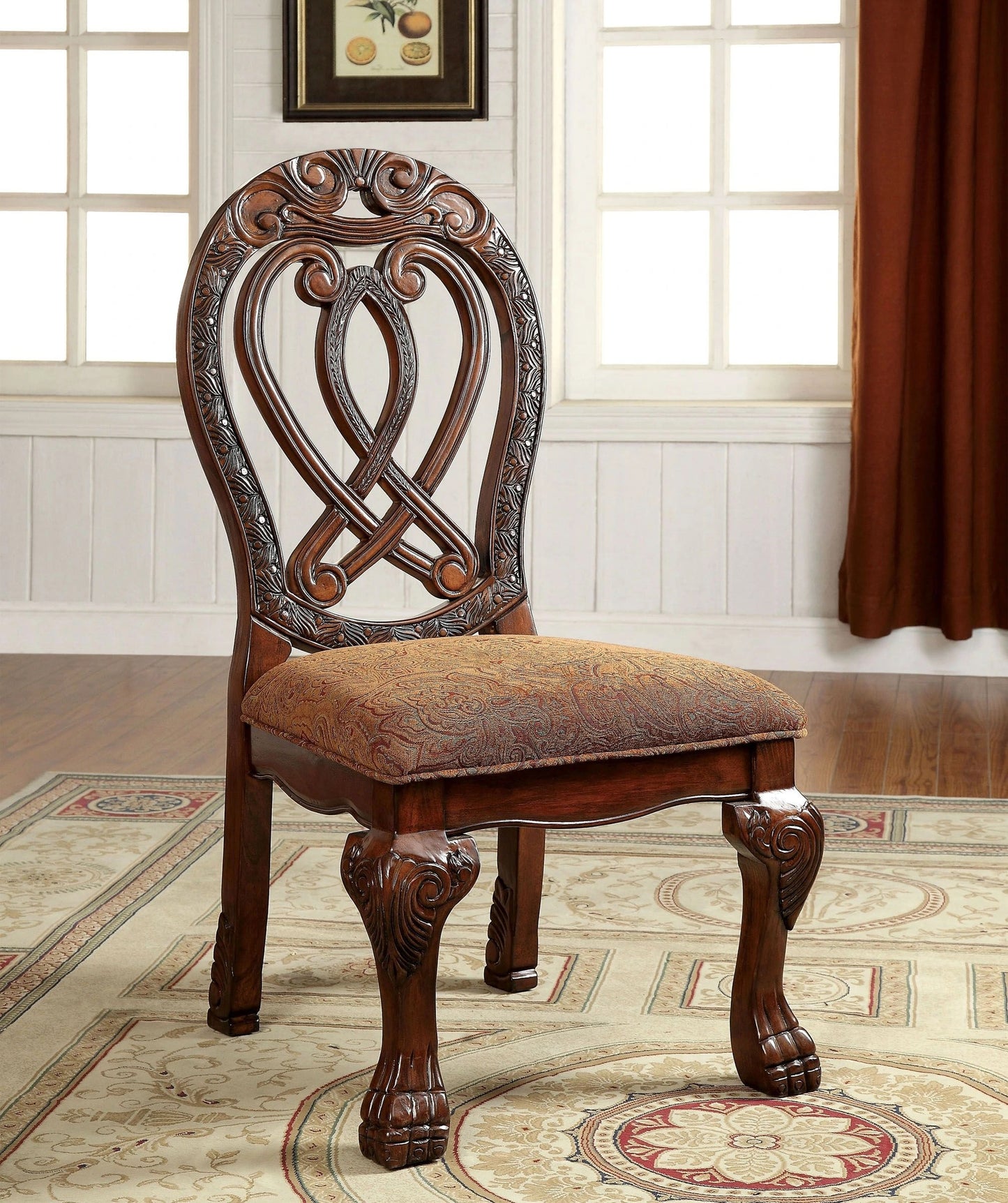 Ornate carved wooden dining chair with a richly patterned upholstered seat in warm tones