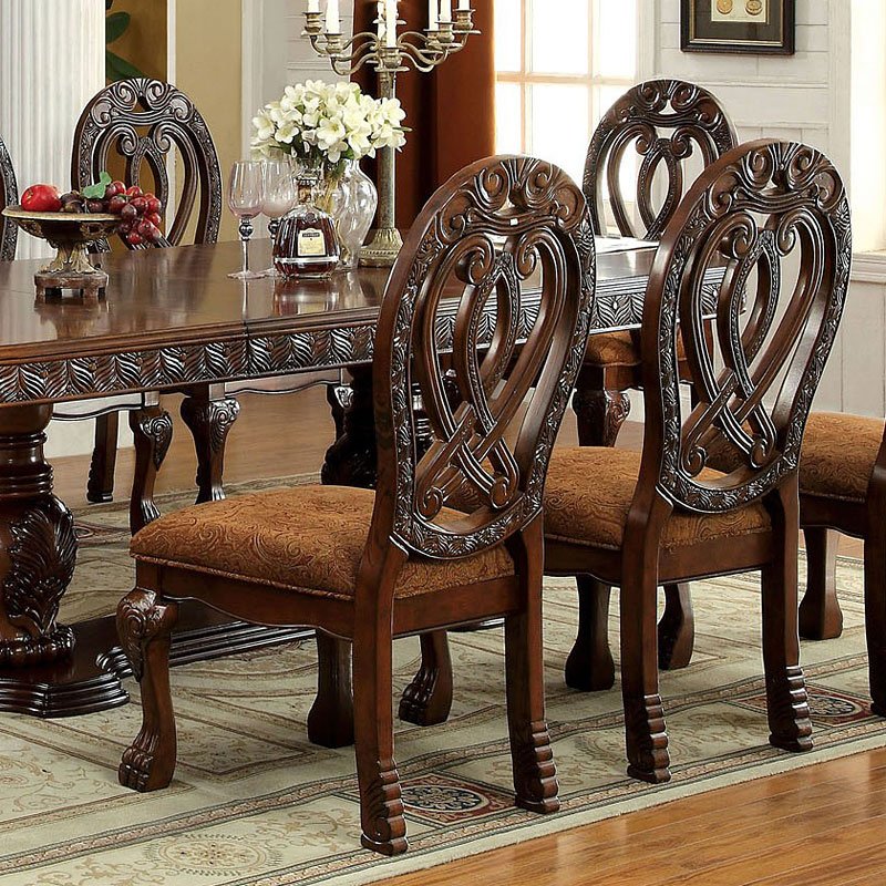 Ornate carved wood dining chair with brown upholstered seat