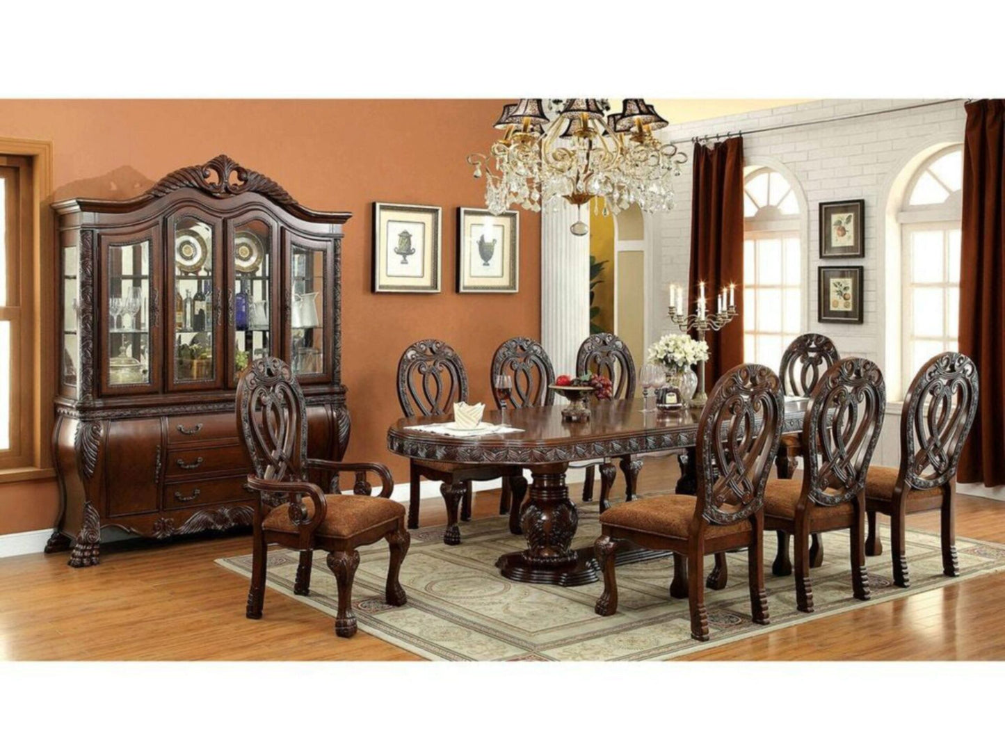 Ornate carved wood dining table with upholstered chairs and matching china cabinet