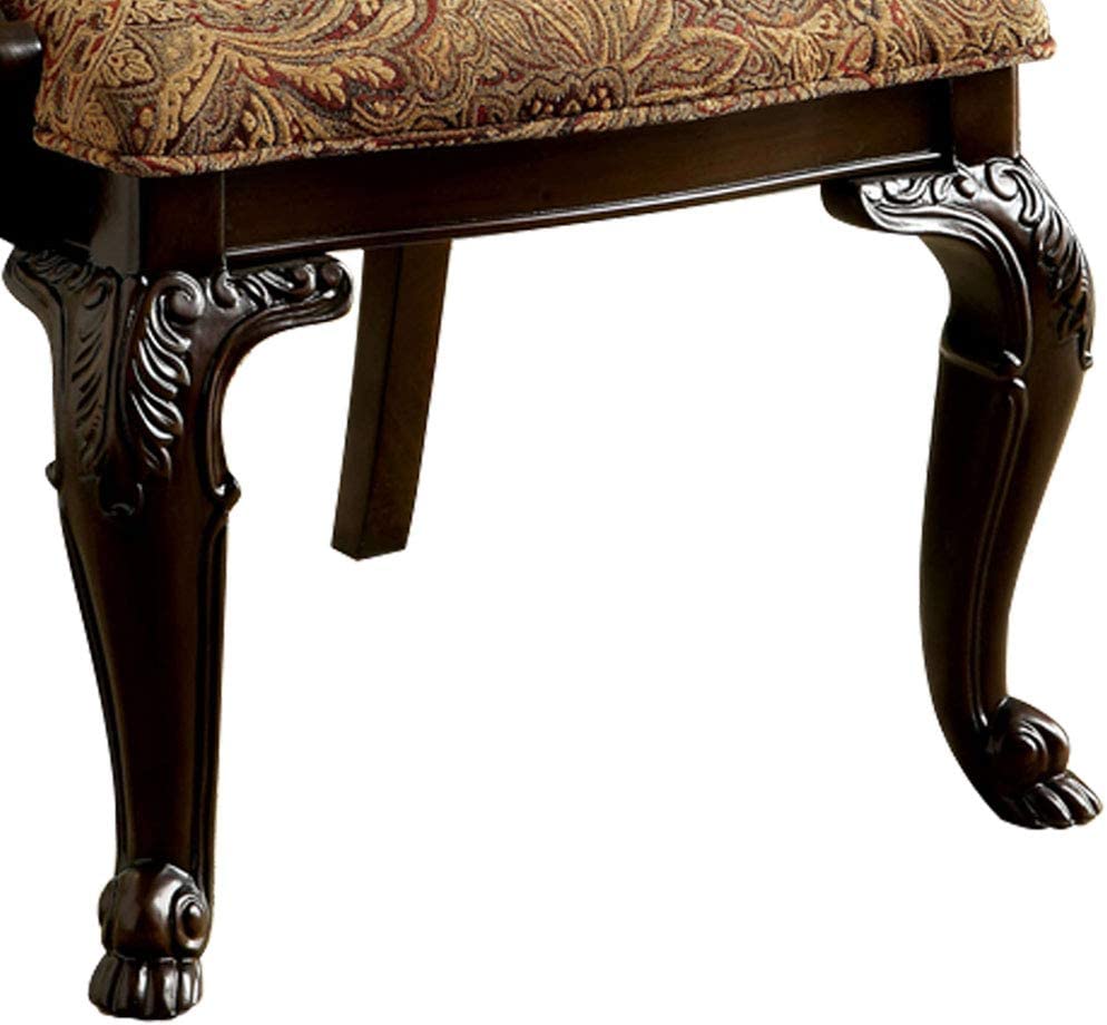 Dark wood ornate chair leg with claw foot and paisley upholstered seat detail