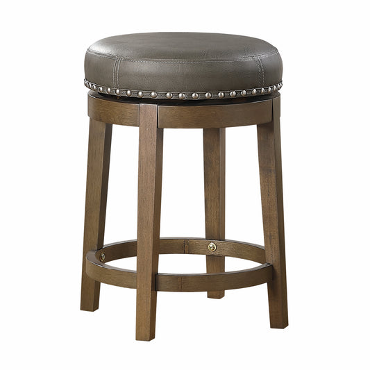 Round gray faux leather bar stool with studded trim and wooden legs