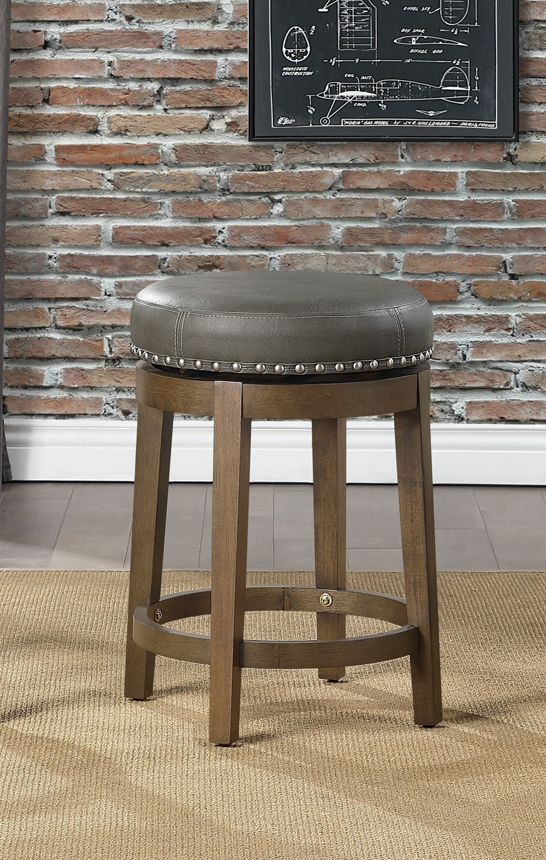Gray upholstered swivel bar stool with nailhead trim and wooden base