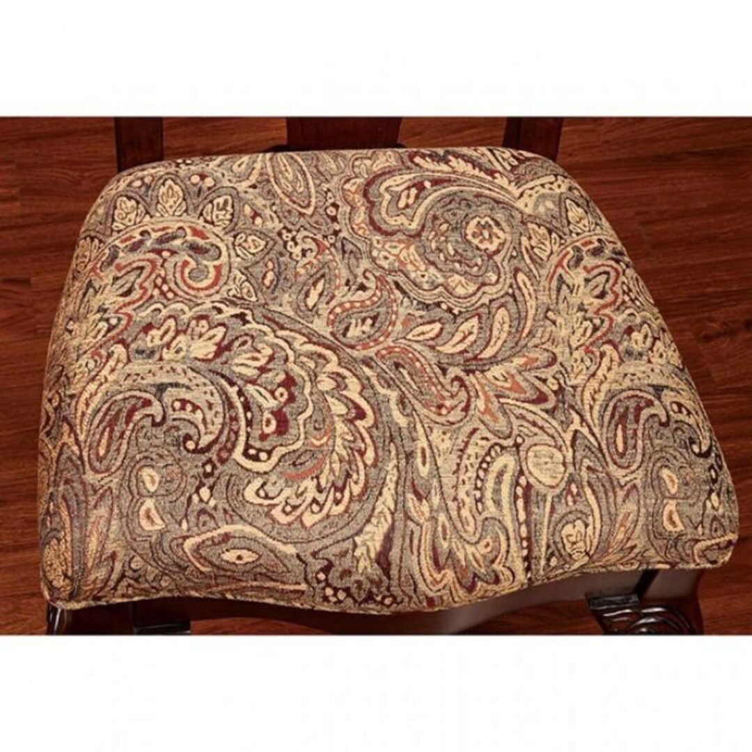 Paisley patterned upholstered dining chair seat in neutral tones with dark wood legs