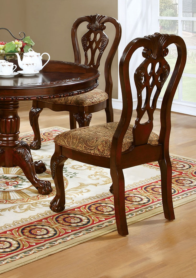 Ornate carved wood dining chair with ornate patterned upholstery and claw feet