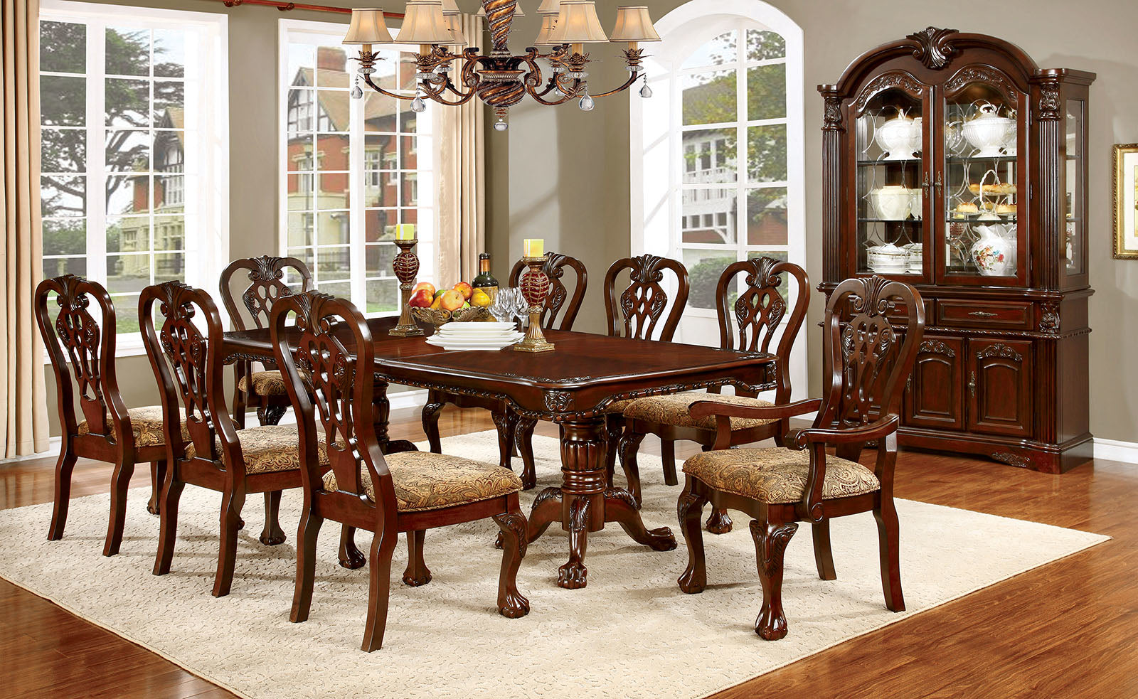 Elegant mahogany dining table with ornate carvings and cushioned chairs seats eight