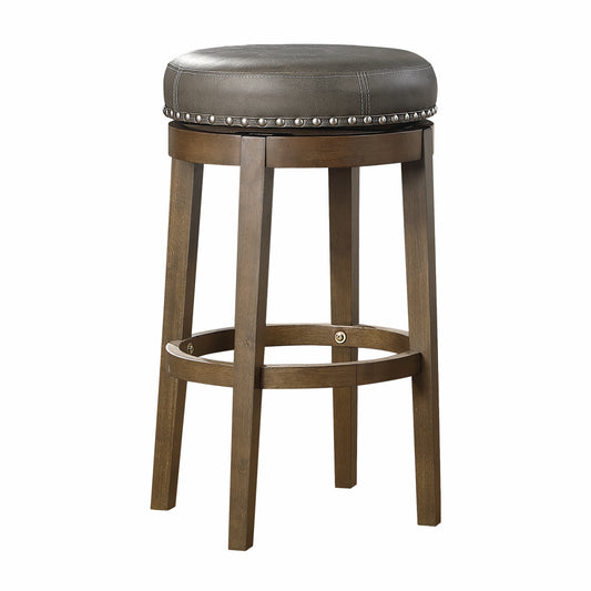 Brown wooden bar stool with a gray faux leather padded seat and silver nailhead trim
