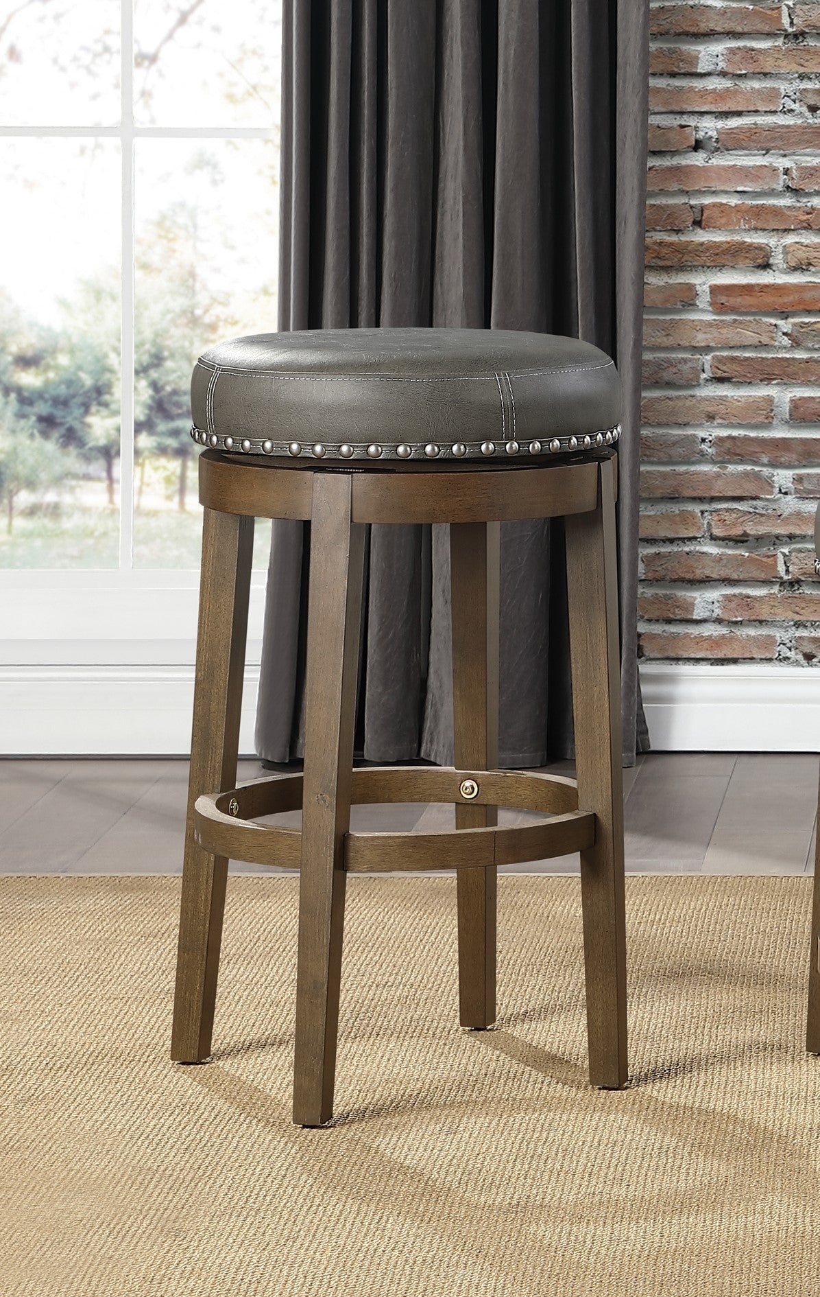 Grey swivel bar stool with nailhead trim and wood base